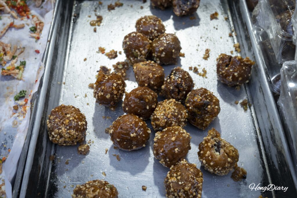 Kkulppang de Jinju (pan de miel coreano) cubierto de almíbar, maní tostado molido y semillas de sésamo
