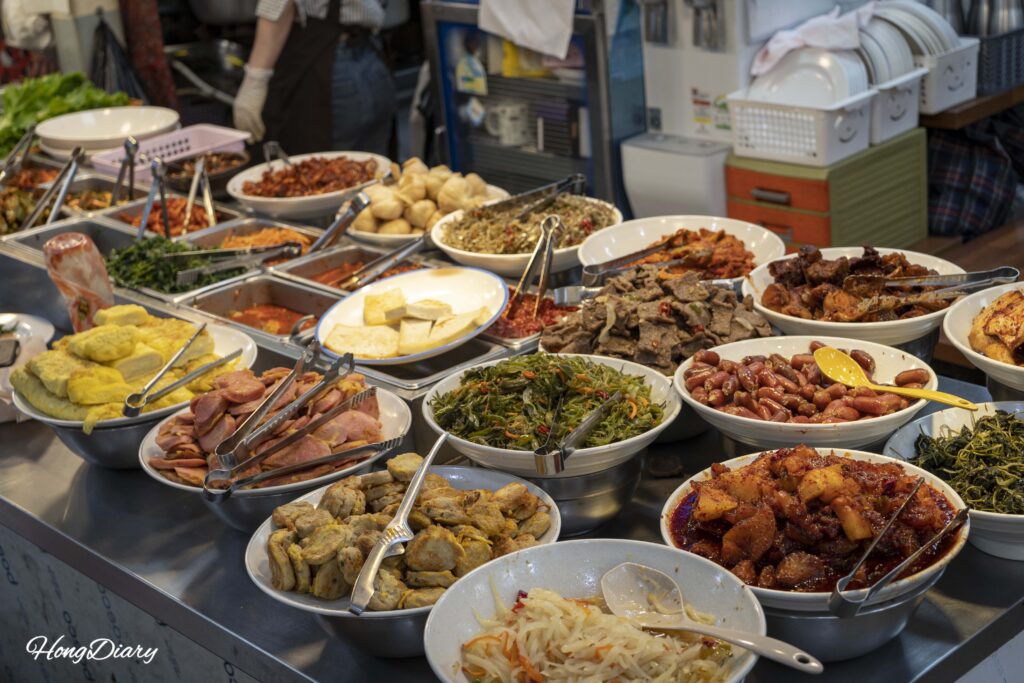 Large spread of Korean banchan side dishes at a buffet-style restaurant inside Seongdong Market Gyeongju