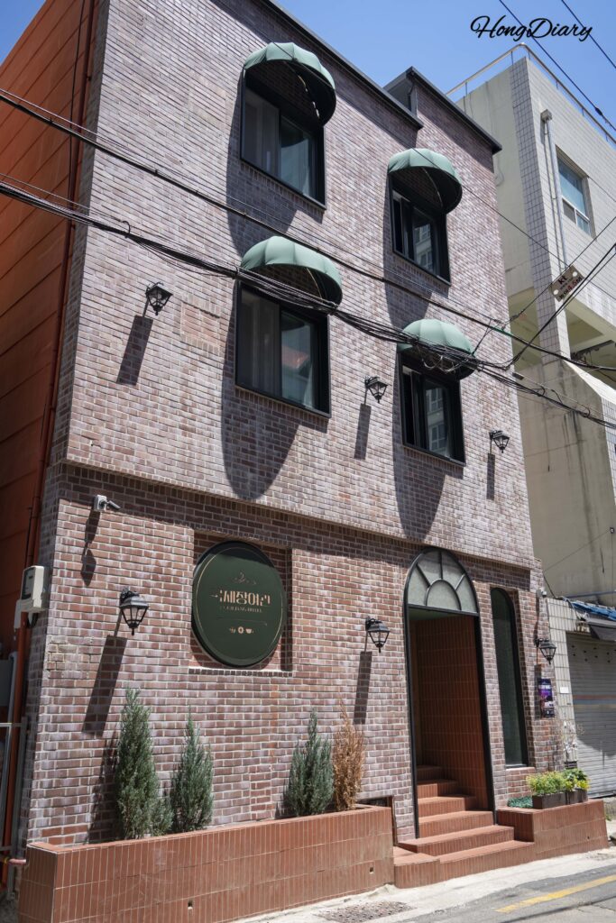 Exterior of Kukjejang Hotel in Seomyeon, Busan with retro signage