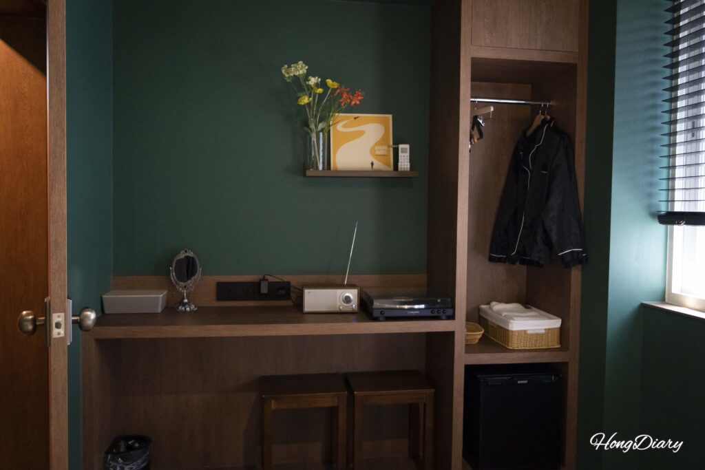 In-room wardrobe and LP record player inside a Kukjejang Hotel guest room