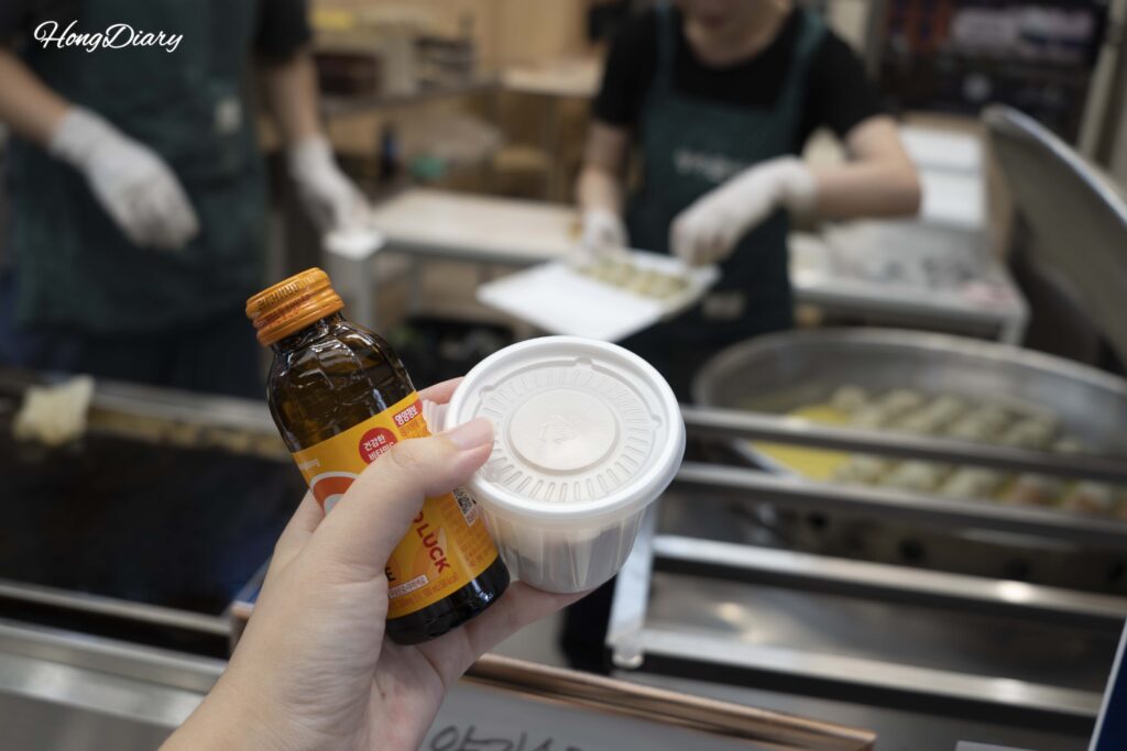 Reward for completing the Mystery Market game — handmade dumplings and a drink at Yangga Son Mandu in Bujeon Market