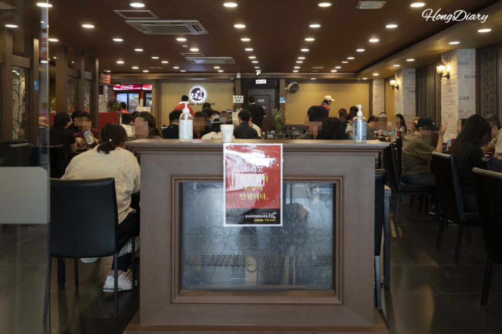 Interior of Rian restaurant in Daegu with chalkboard waitlist
