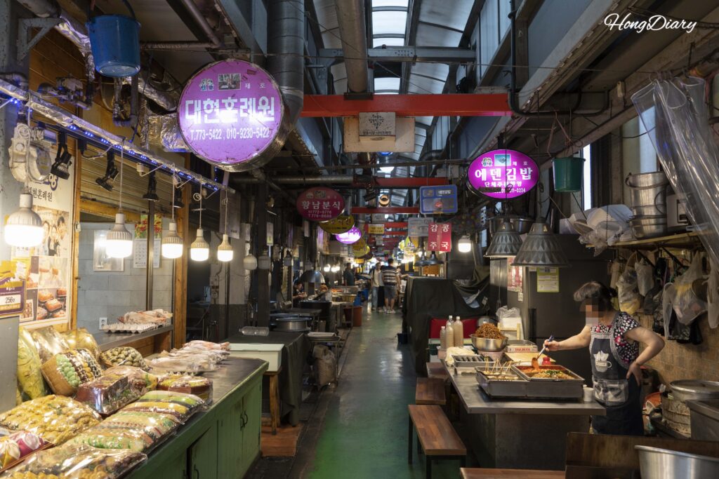 Narrow food alley lined with restaurants and street food stalls inside Seongdong Market Gyeongju