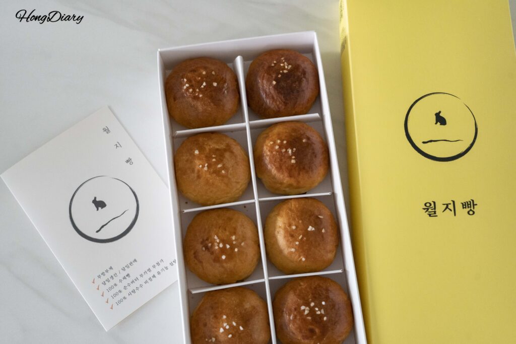 Opened Wolji Bread gift box revealing 10 moon-shaped salt bread rolls inside