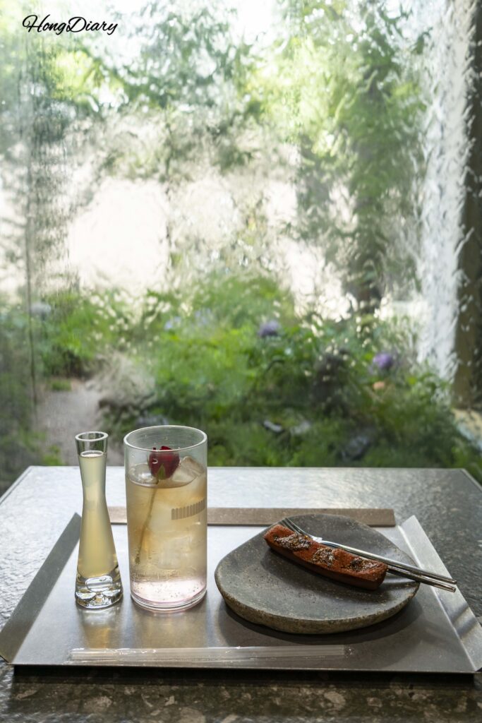 Signature April Flower Ade and financier on a table in the summer room at Yeoldudal Cafe