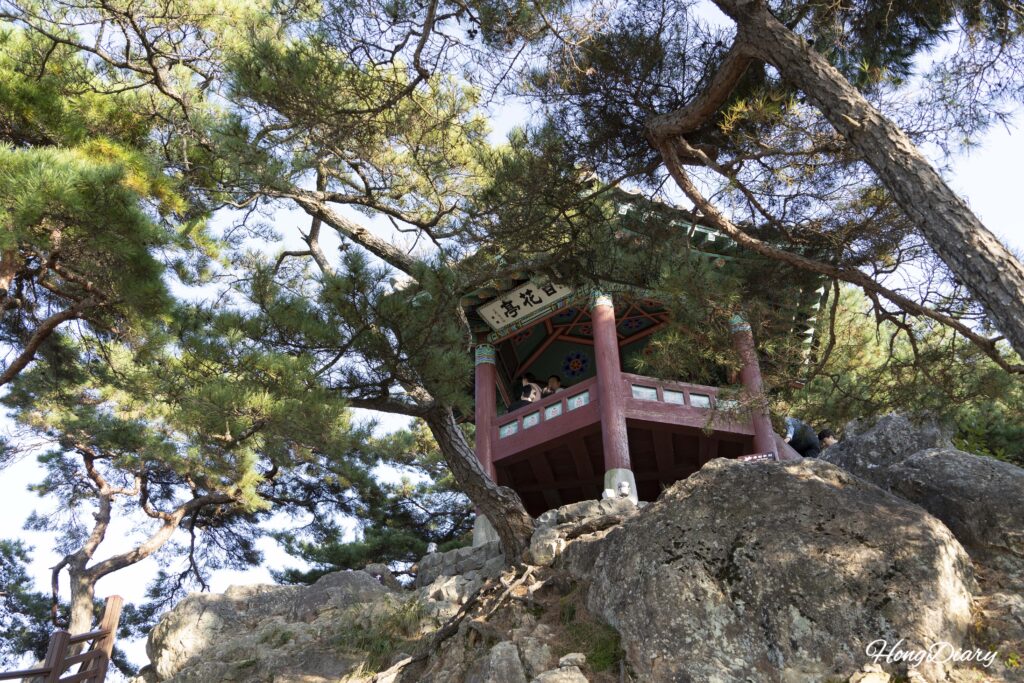 Baekhwajeong Pavilion, a traditional wooden structure perched above the Nakhwaam Rock cliff in Buyeo