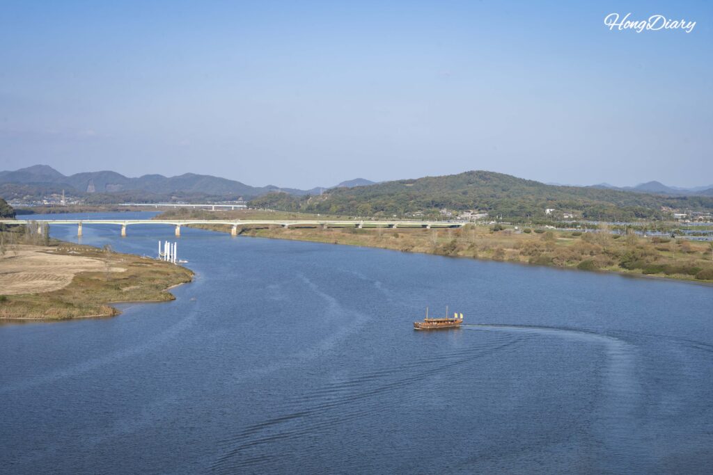 Traditional hwangpo sailboat river cruise on the Baengmagang River below Nakhwaam Rock in Buyeo