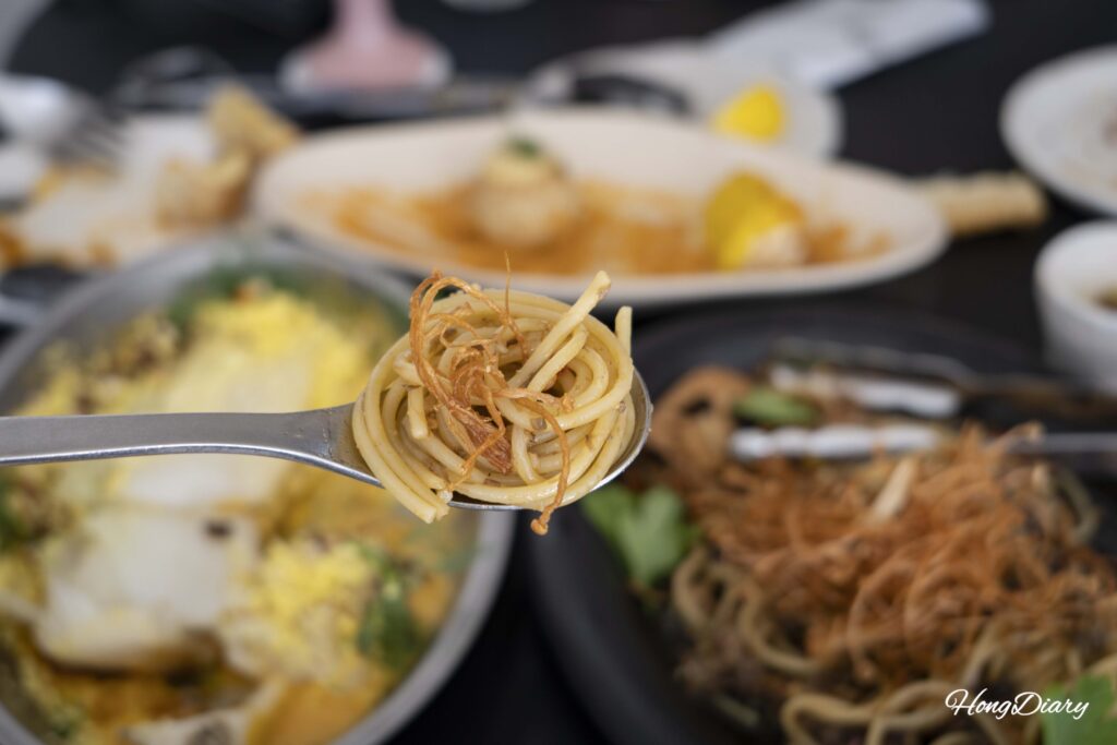 Closeup of bracken fern pasta on a spoon showing the chewy fern texture at ARP restaurant in Busan