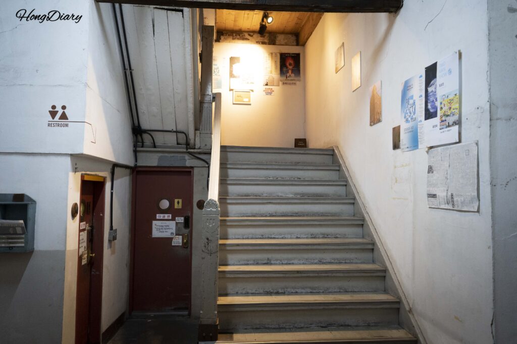 Narrow hallway and restroom area inside the former Baekje Hospital building, now Brown Hands Baekje cafe in Busan
