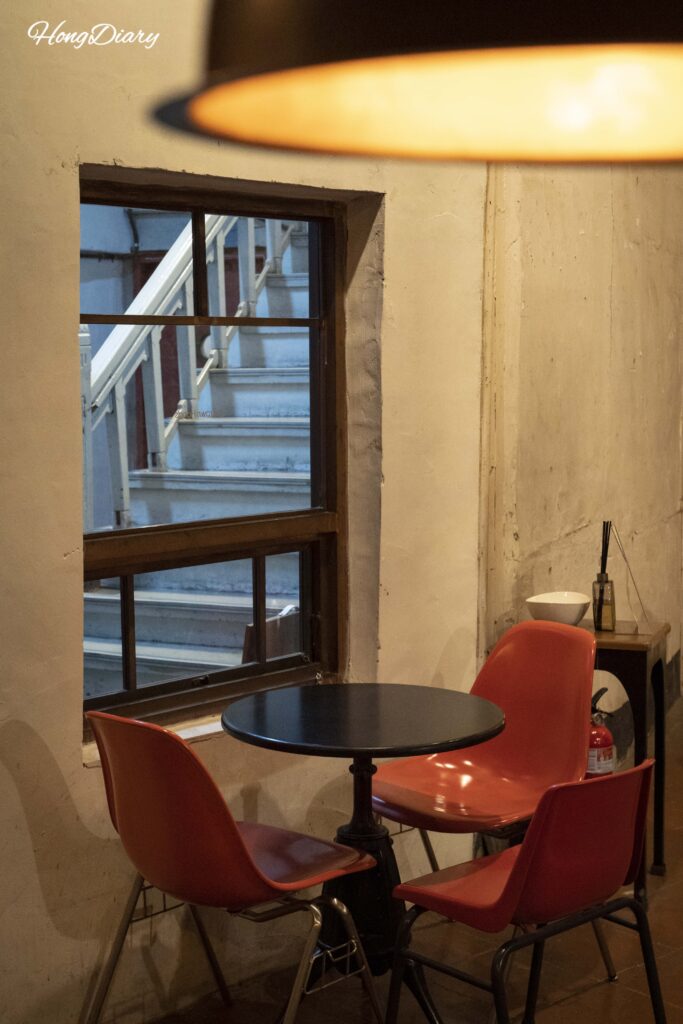 Seating area at Brown Hands Baekje cafe with tall wooden window frames in the former Baekje Hospital, Busan