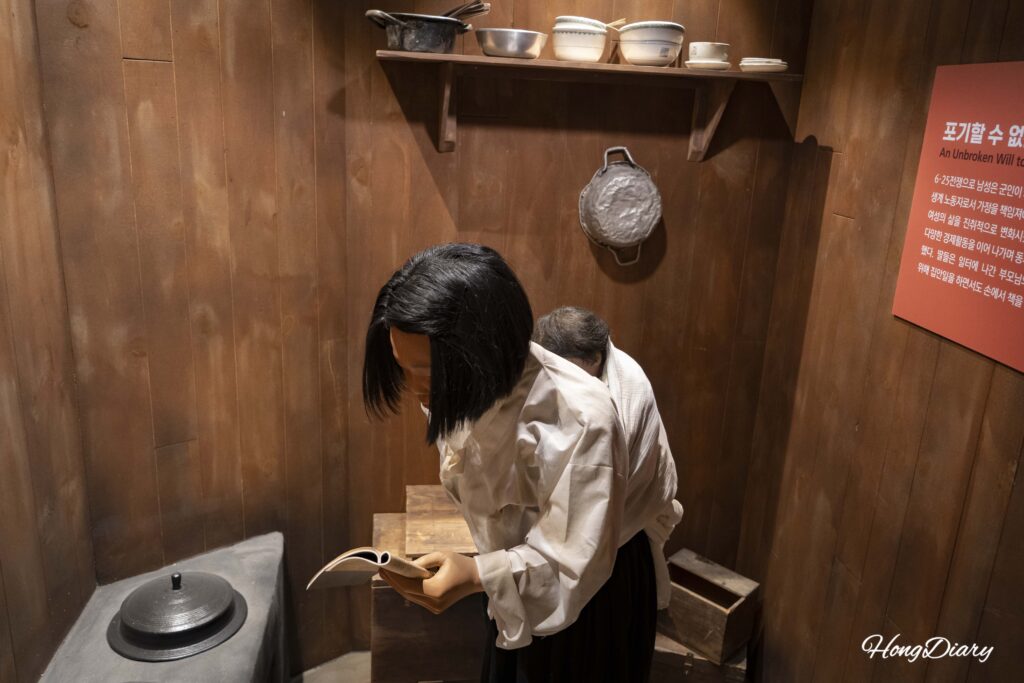 Life-size model of a Korean War refugee student studying at home, displayed at the Busan Education History Museum
