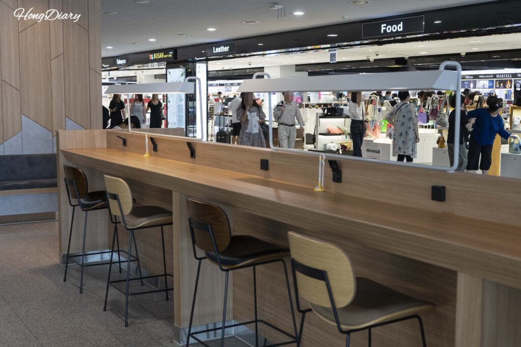 Departure waiting area at Busan ferry terminal with charging outlets at individual seats and tables