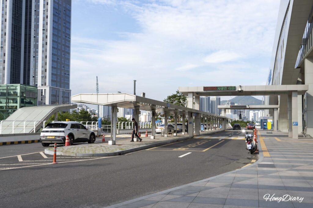 Gate 3 entrance of Busan Port International Passenger Terminal with taxis waiting outside