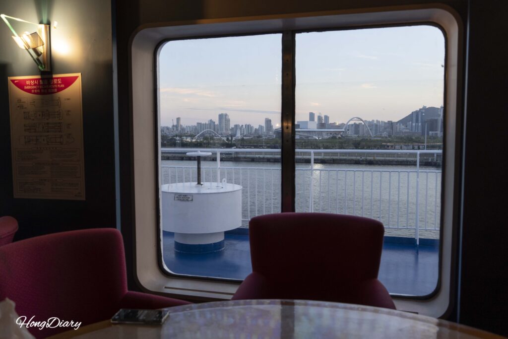 Sunset over Busan Harbor seen through the Multi Hall window on the Seonghee ferry