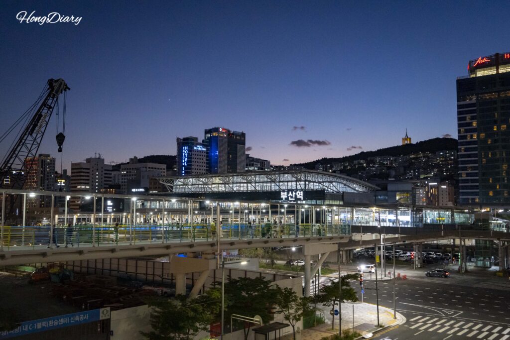 Night view of KTX Busan Station exterior with city lights, starting point for North Port Waterfront Park walk