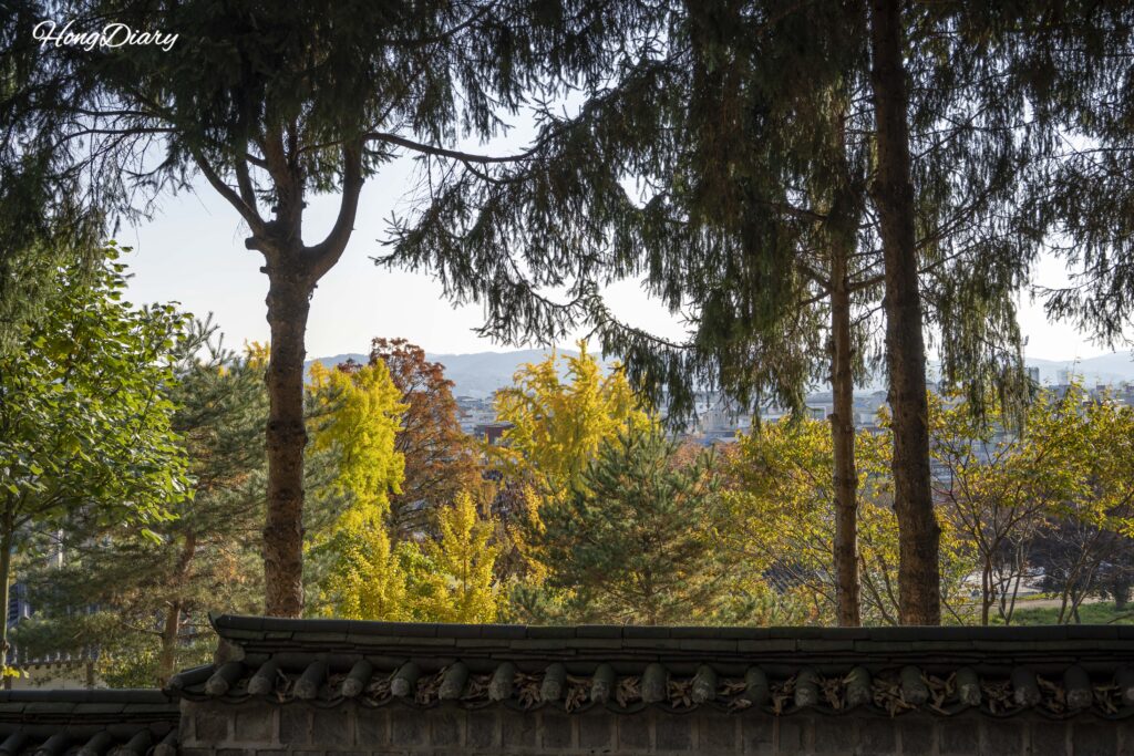 Ancient stone fortress wall with early autumn foliage along the Busosanseong descent path in Buyeo