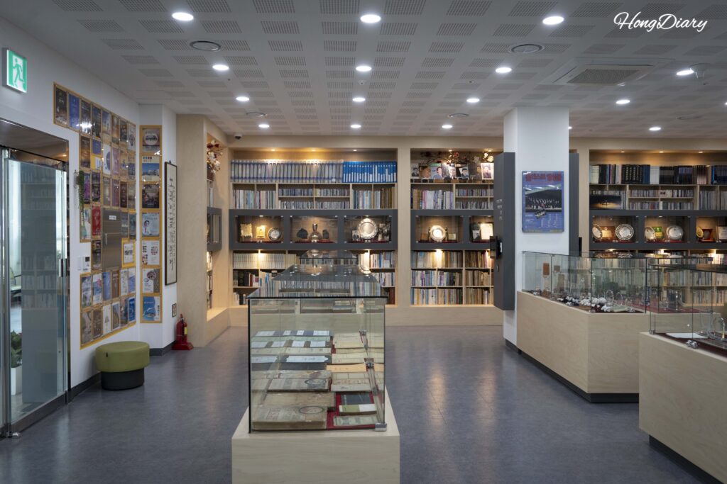 Display cases with donated vinyl records, music scores, and personal memorabilia inside the Eom Jeong-haeng Museum in Yangsan