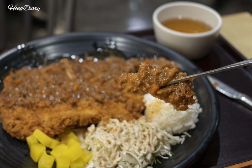 Close-up of the crispy giant pork cutlet (wang donkkaseu) at Plating food court in Gimhae Airport