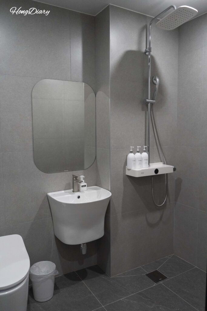 Clean modern bathroom with walk-in shower and bidet toilet at Giverny Hotel Gyeongju
