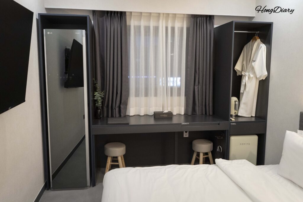 Interior of the Deluxe room at Giverny Hotel Gyeongju showing double bed, desk, and LG Styler