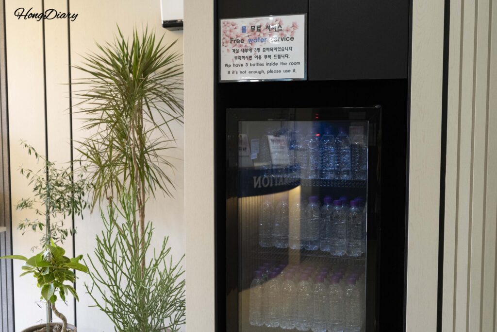 Refrigerator stocked with free bottled water for guests at Giverny Hotel Gyeongju lobby
