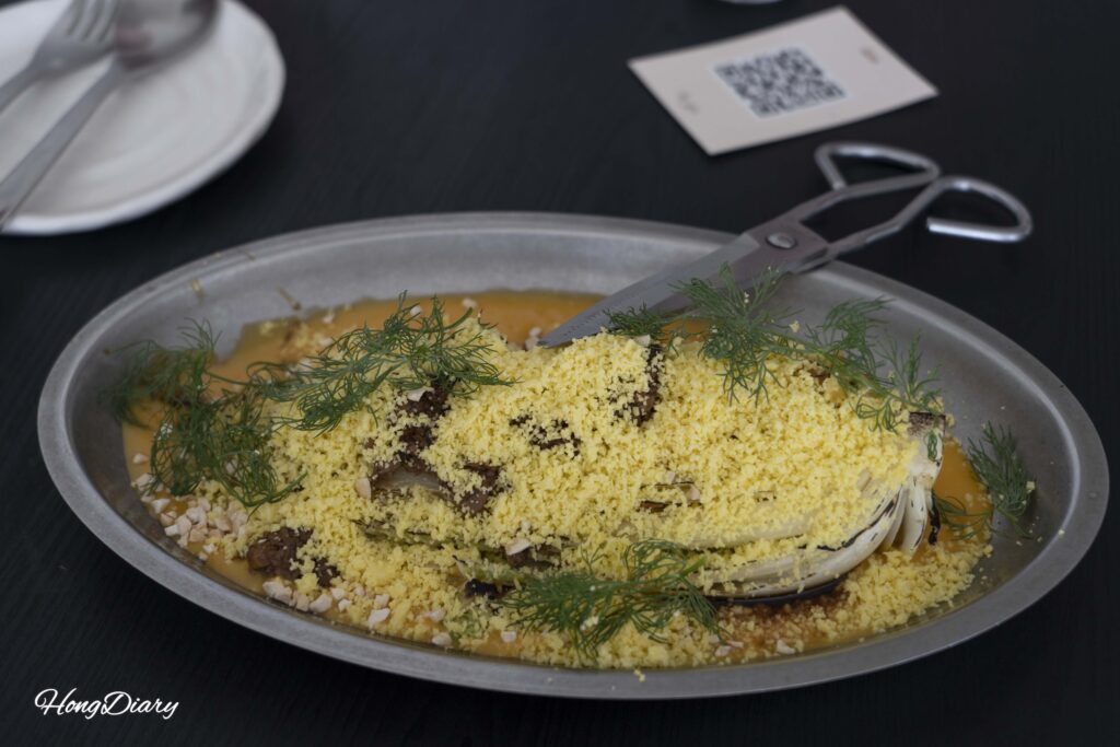 Grilled baby cabbage served on potato sauce with vegan cheese at ARP restaurant in Yeongdo, Busan