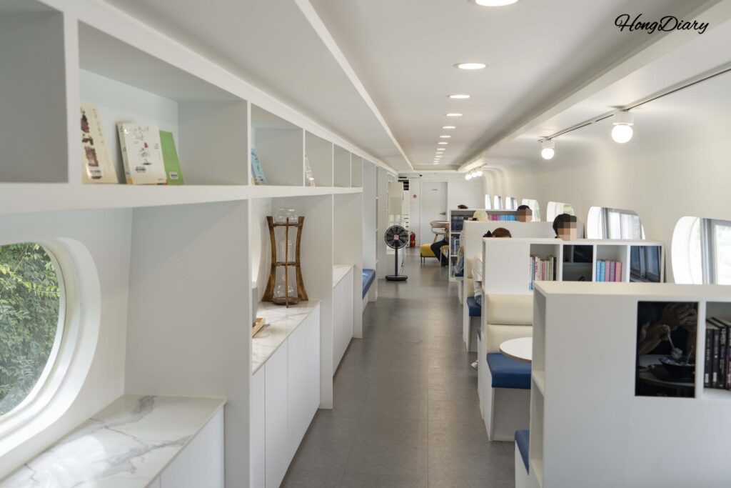 Interior of Honeybee Travel Train Cafe inside a retired railcar at Jinyeong Railway Museum in Gimhae