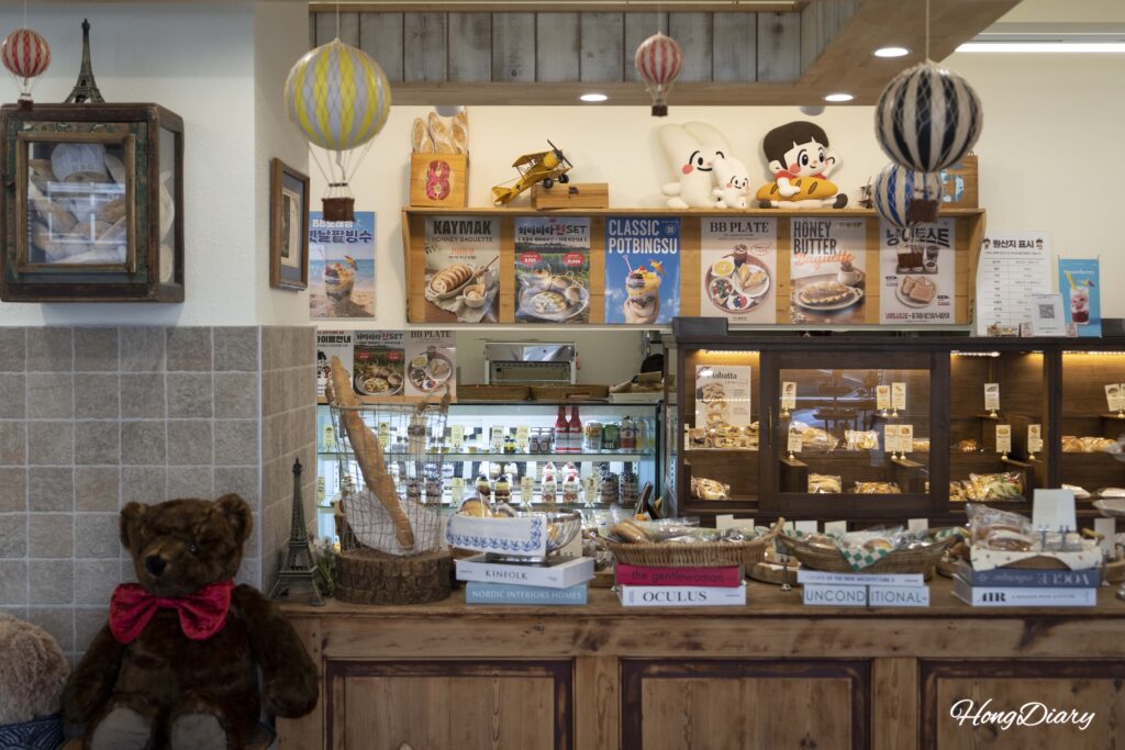 Interior view of House of Bread BB showing menu posters bakery display and cafe decor in Gwangalli Busan