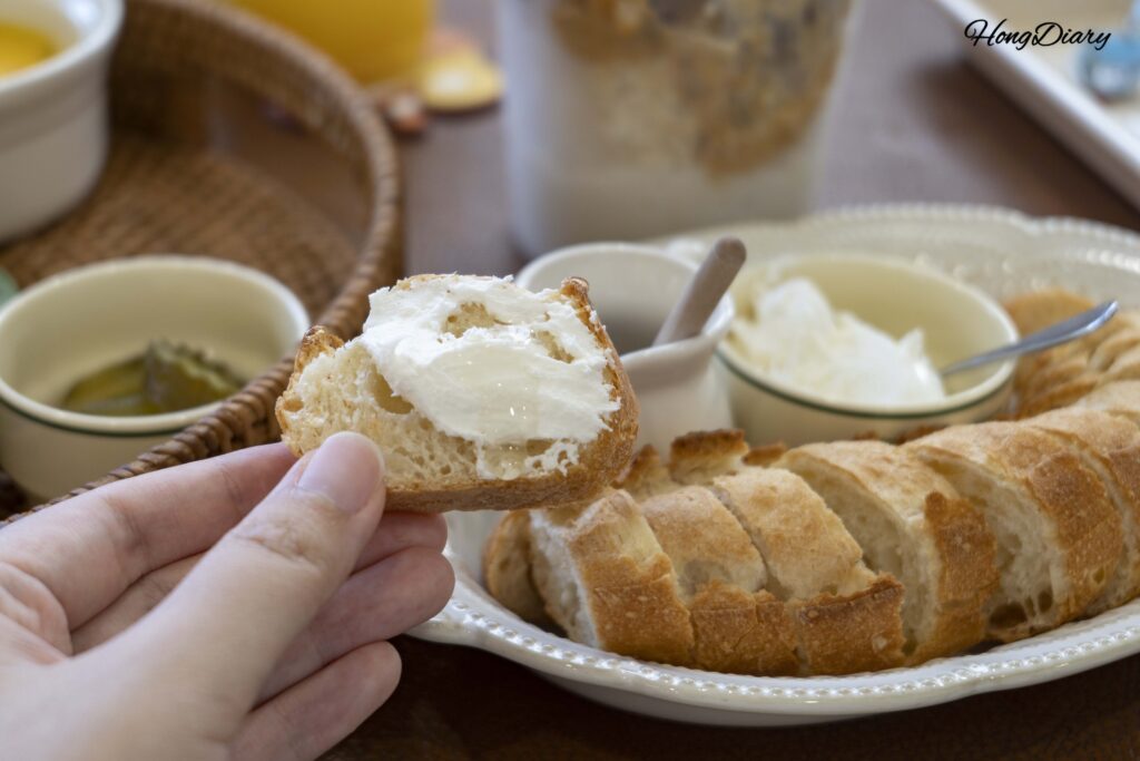 Spreading house-made Turkish kaymak cream on baguette with honey at House of Bread BB Gwangalli