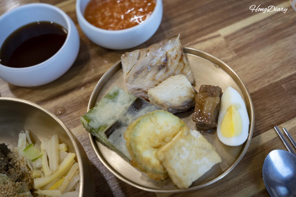 Assorted Korean jeon (pan-fried dishes) including egg, tofu, fish, and vegetable varieties served with heotjesabap in Andong