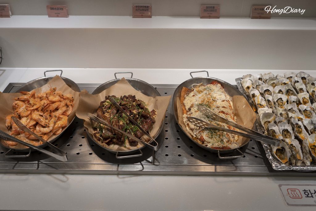 Grilled salmon, shrimp, oysters, and lamb chops at QooQoo hot food station