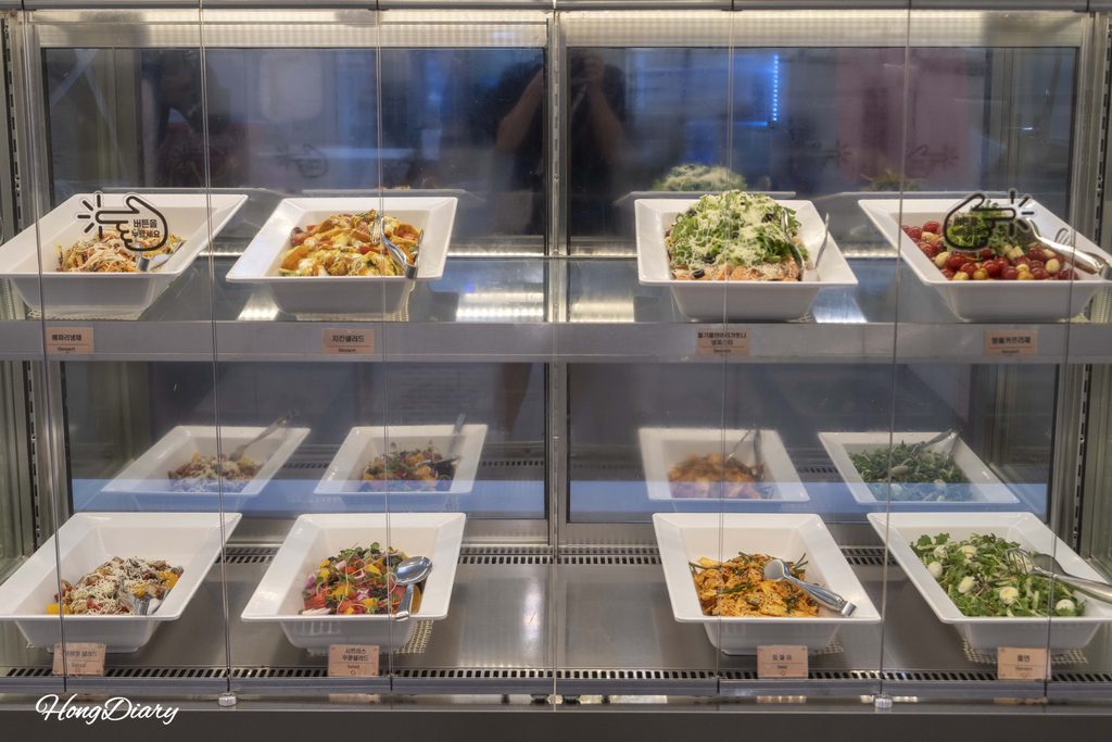 Salad bar with fresh greens and toppings at QooQoo sushi buffet