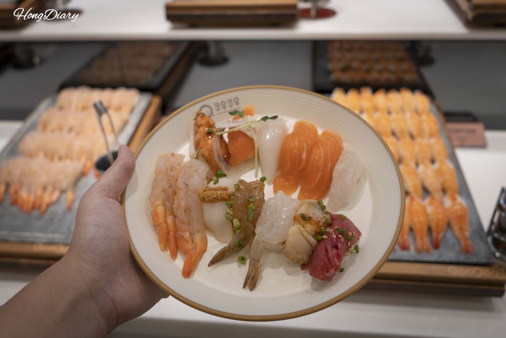 Plate loaded with assorted sushi selected from the QooQoo buffet counter