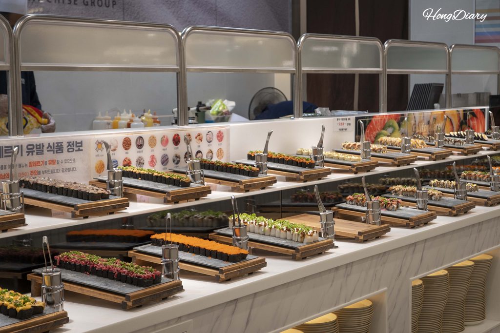 Wide selection of nigiri sushi and rolls at the QooQoo buffet counter