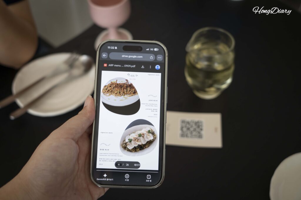 Customer scanning a QR code card to view the digital menu at ARP restaurant in Busan