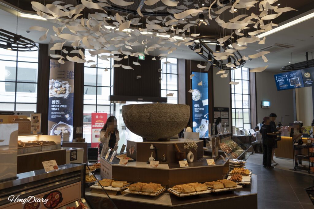 Tourists browsing the bakery-style fish cake displays inside the Samjin Yeongdo flagship