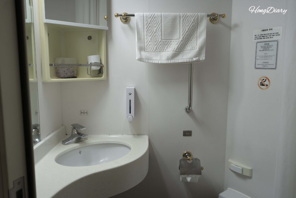 Private bathroom with toilet inside the 4-person tatami cabin on the Seonghee ferry