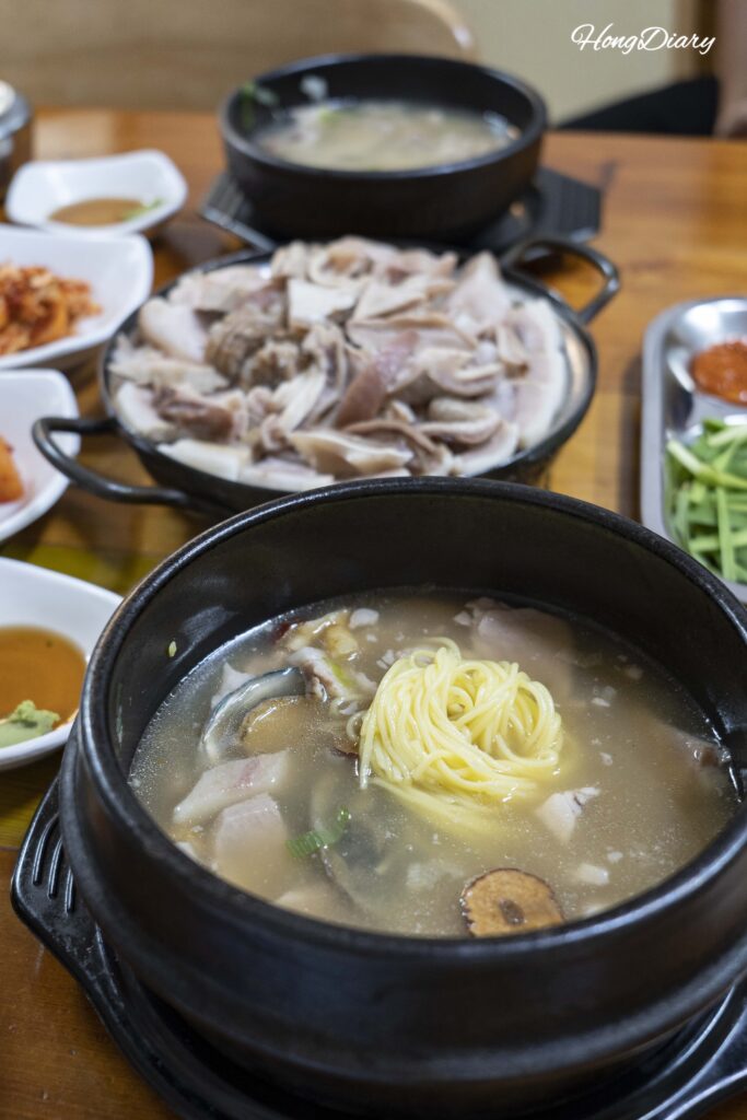 Donsamjeonboktang (sopa de cerdo con ginseng y abulón) y otros platos servidos en Seonjeongmun Dwaeji Gukbap, Busan