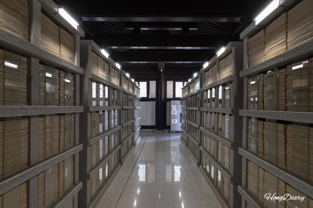 Narrow corridor inside Janggyeong-gak lined floor-to-ceiling with ceramic Tripitaka plates at Seounam Hermitage