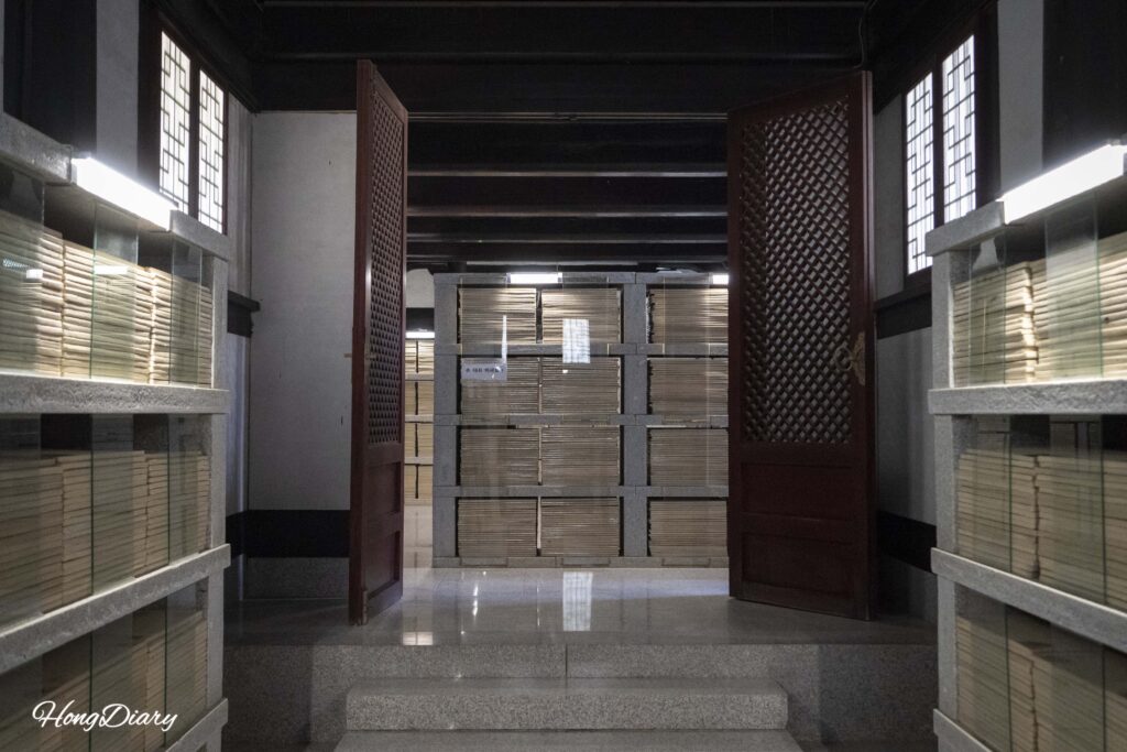 Floor-to-ceiling shelves stacked with ceramic Tripitaka Koreana plates inside Janggyeong-gak at Seounam Hermitage