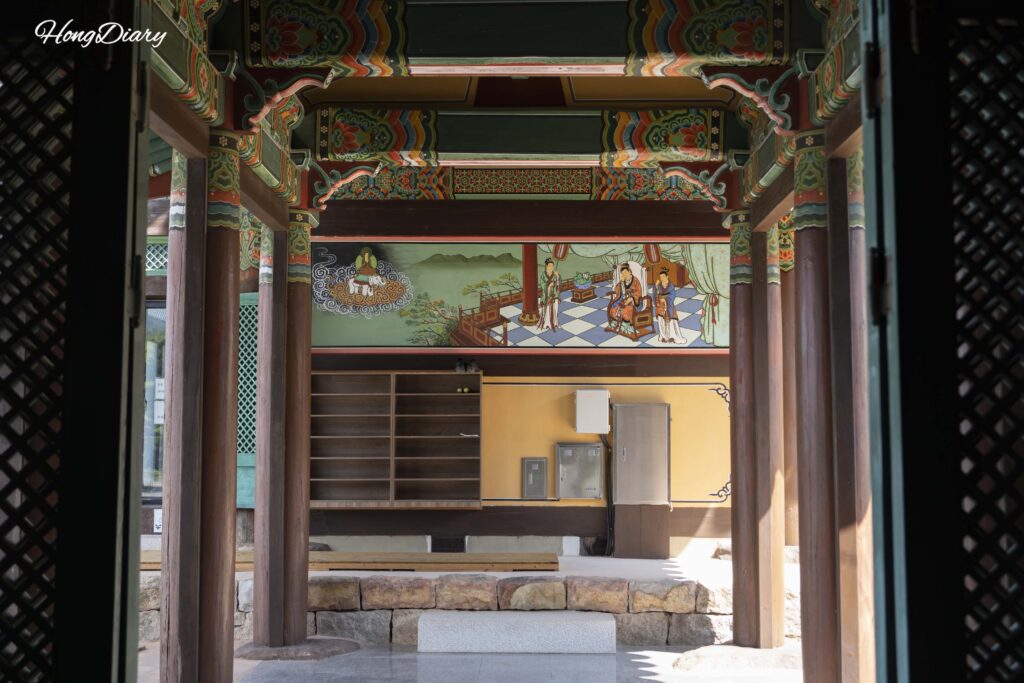 Entrance to Janggyeong-gak (scripture repository hall) at Seounam Hermitage showing traditional Buddhist murals on the walls