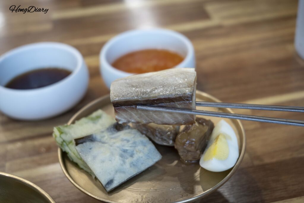 Close-up of shark meat sanjeok skewers with onion and beef, a traditional Andong ritual food dish