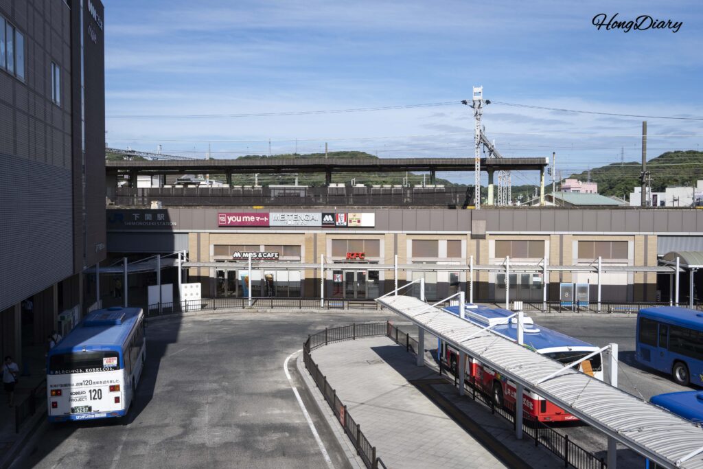 Overhead view of JR Shimonoseki Station and local buses from the elevated pedestrian walkway