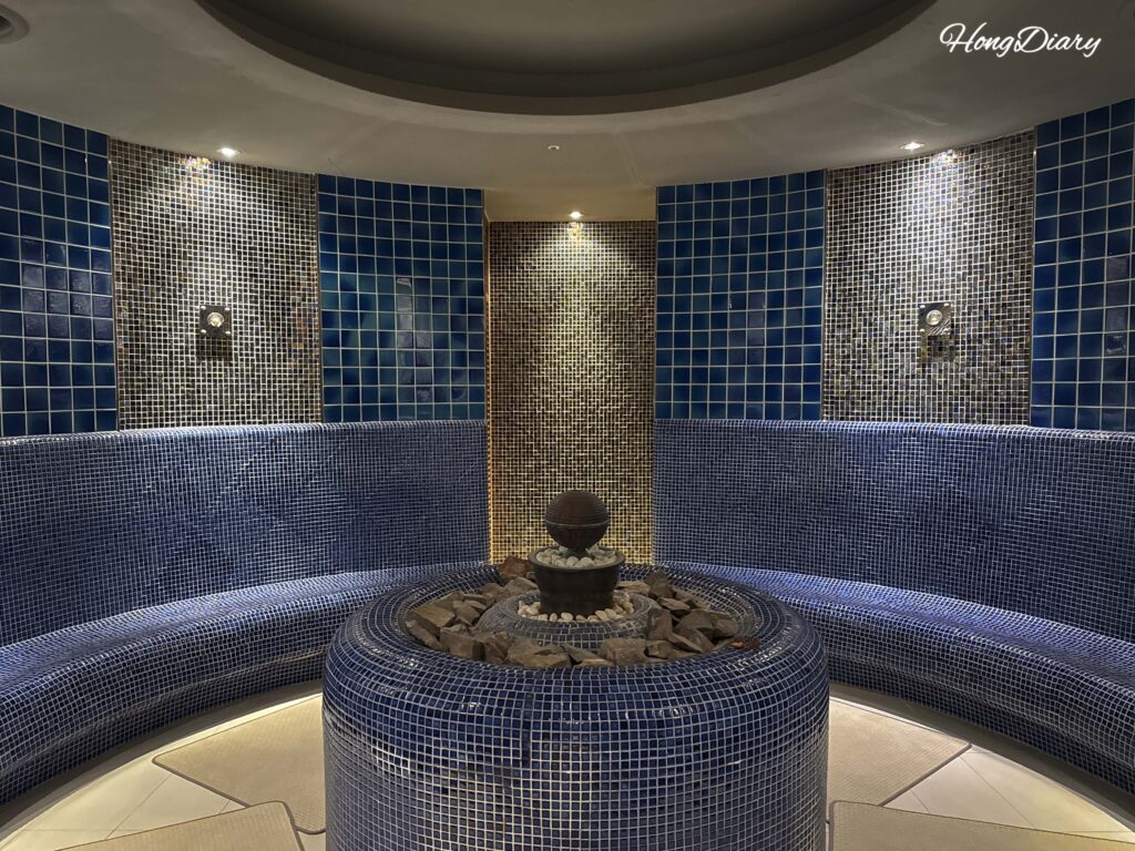 Interior of one of the 13 themed sauna rooms inside Spa Land Busan showing stone platforms and warm lighting