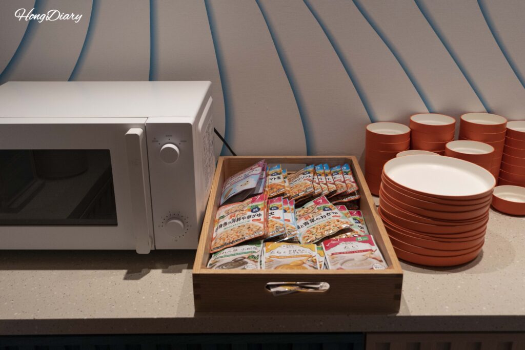 Baby food station with pouches, child-sized tableware, and microwave at PUKU PUKU, RISONARE Shimonoseki