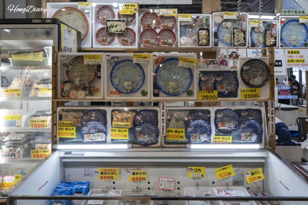 Restaurante de sashimi de fugu famoso en el Mercado Karato con autógrafos de celebridades en la pared y platos de fugu en exhibición
