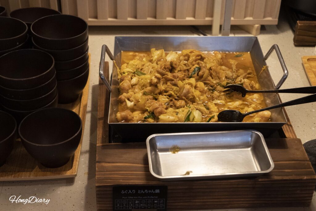 Stir-fried fugu and thinly sliced pork in savory broth at PUKU PUKU