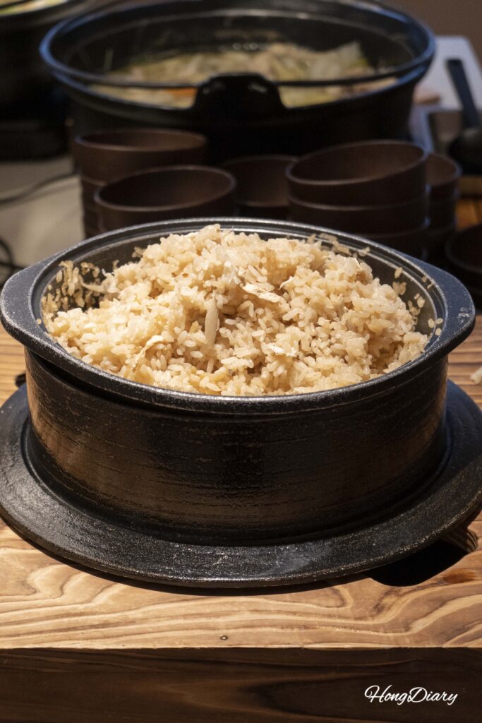 Close-up of fugu rice cooked in a clay pot at the Fugu Market Corner in PUKU PUKU