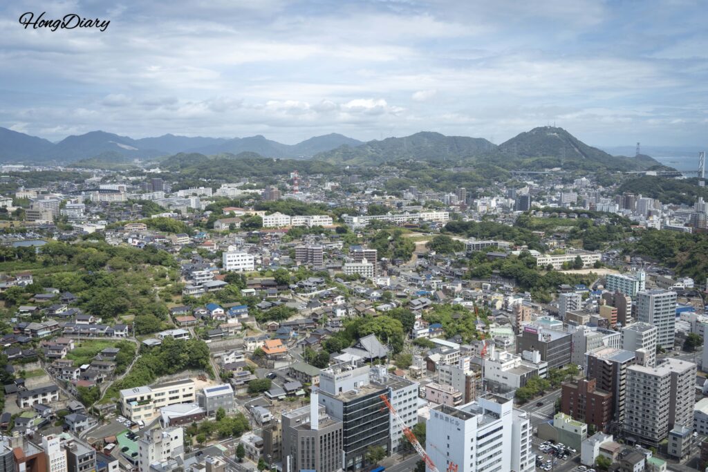 North-facing view from the 30th floor of Kaikyo Yume Tower showing the residential streets and city center of Shimonoseki