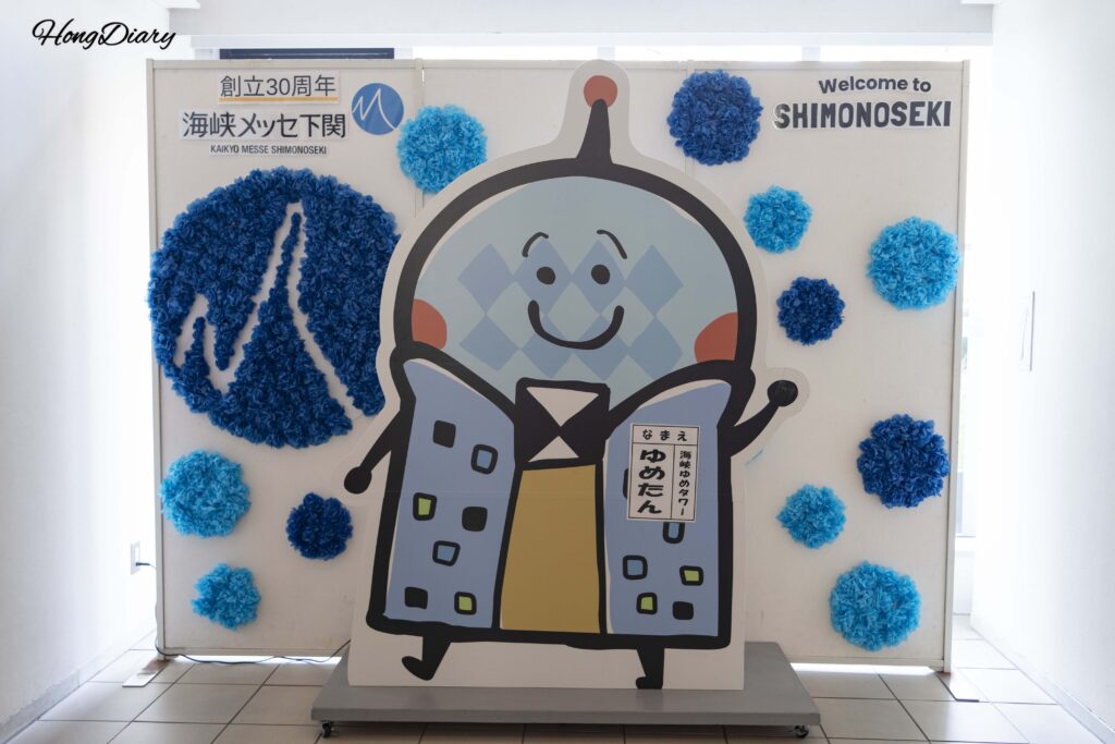 Yume-tan mascot character photo zone near the elevator entrance to the Kaikyo Yume Tower observation deck